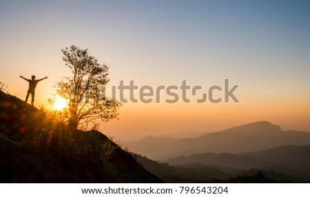 Take a picture of the morning sunrise at the top of a hill in the new day.