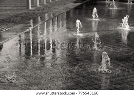 Black and white image of fountains in the courtyard of the Design Museum London