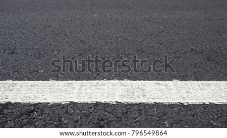 Surface rough of asphalt, Grey with white line on grainy road, Texture Background, Close up