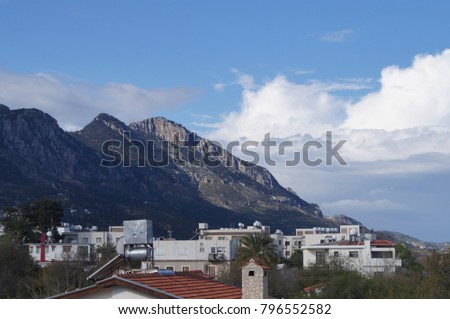 Mountain city landscape. European town. Nature urbun background. Mountain backdrop. Mediterranean town. Blue sky with clouds. Color phography.