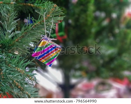 close up of small or mini present box hanging on the christmas or xmas tree. new year,celebration,xmas concept.