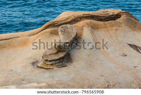 A picture of Yehliu's famous Fairy’s Shoe Rock which belongs to the ginger rock category. It was formed due to seawater erosion on rock layer that contains rocks of different hardness.