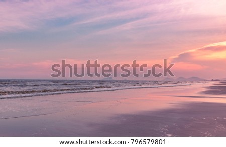 Colorful atmosphere on the beach in sunset time. Beautiful sky and reflex color on the beach. Blank space for text.