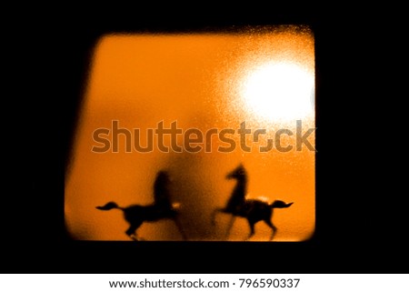 silhouette of horses behind the mirror