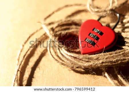 
Soft focus,Red key in heart shape with natural straw rope on wooden table background. Concept of love for Valentine's Day celebration.