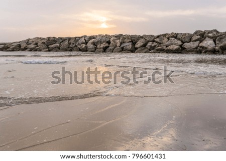 Sea waves at sunset on the beach