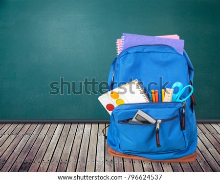 School bag on wooden table
