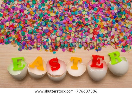 shell of white Easter Eggs - word easter made from colorful letters and many motley confetti on background. happy easter - holiday background. 