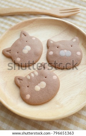 Close Up Homemade Chocolate Cookies Cat Face in Wooden Plate and Fork Ready to Serve