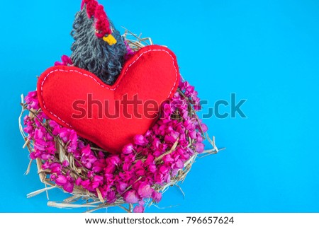 Red heart in spring flower nest on blue background.
 Easter holiday concept with copy space,Top view.Valentine's day concept.