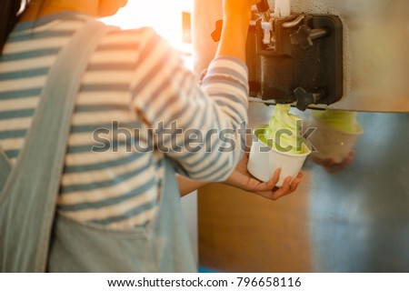 The woman make ice cream from the machine.