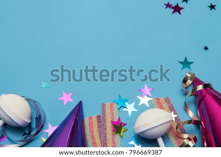Party background image with party hats, string and colourful sweets, taken with copy space 