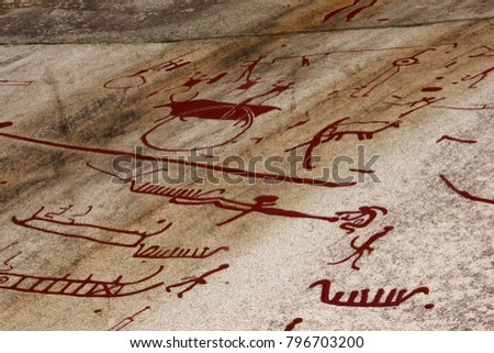 A prehistorical drawing in Sweden. Painting shows the boats, people and animals. 