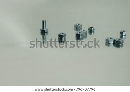 more mounting bolts and nuts on a metallic background