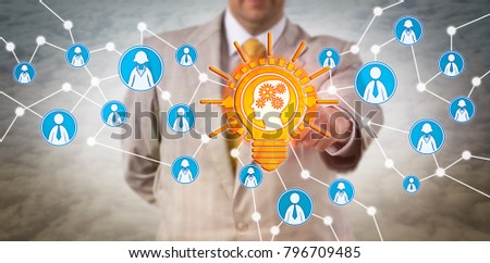 Unrecognizable recruiter touching a learning mind in lightbulb. Concept for artificial intelligence, machine learning, personal development, talent acquisition, knowledge transfer and inspiration.