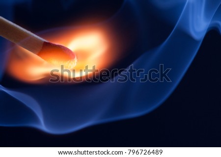A match take fire and causes smoke emission Royalty-Free Stock Photo #796726489