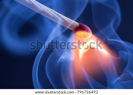 A match take fire and causes smoke emission Royalty-Free Stock Photo #796726492