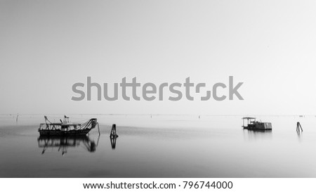 Fishing boats inside Po river lagoon, Italy. Italian landscape. Minimal water panorama. Image digitally altered