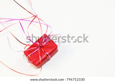 A red little gift lie on a white background.