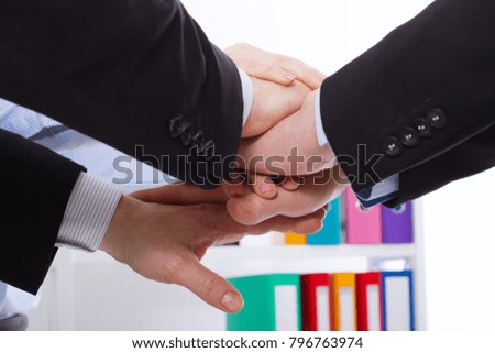 Business team holding hands together at the office. Selective focus and macro arms. Success, support , together