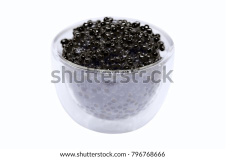 Black caviar in glassware isolated on white background
