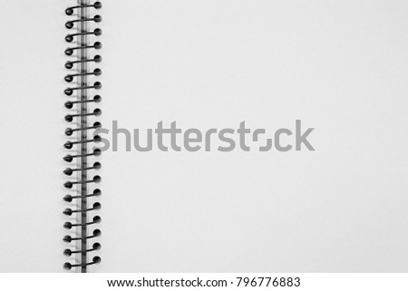Notebook on a spiral spring with textured papper of white color as the background