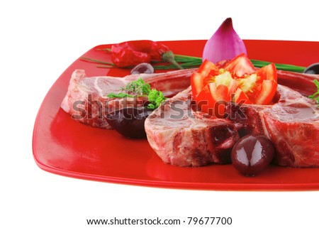 uncooked meat ribs served on red plate