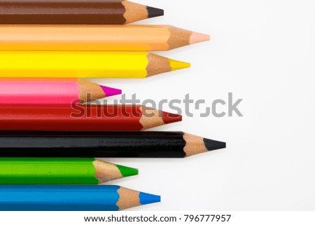 Colored pencils on white background (brown, yellow, pink, red, black, green, blue, beige)