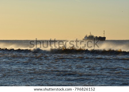 Sea trawler on North Sea (the Netherlands), waves on the beach of Texel.  Europe.