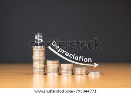 STACKED US QUARTER COINS ON WOODEN TABLE WITH WHITE ILLUSTRATION SHOWS DEPRECIATION IN US DOLLAR VALUE / FINANCIAL CONCEPT Royalty-Free Stock Photo #796844971