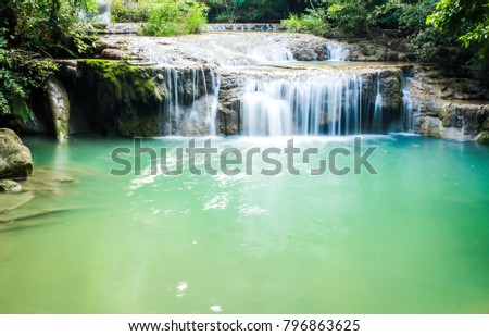 Defocused The Erawan Waterfall, located in Kanchanaburi, Thailand, is a National Park and waterfall that consists of 7 different levels. Blue Water. Blurred picture. Blurred Background.