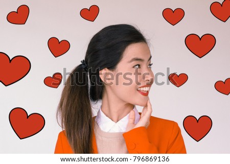 Valentines Day concept- Headshot portrait of long black hair young asian woman wearing red suit and smiling with red heart illustration doodle icon at the back ground