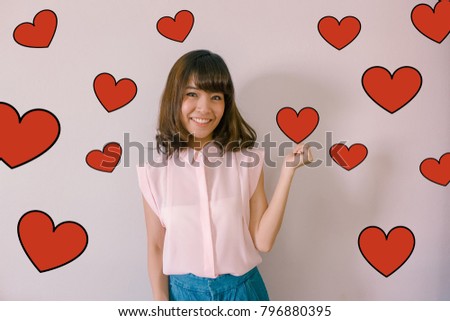 Valentines Day concept- Headshot portrait of a hipster young asian woman smiling with red heart illustration doodle icon at the back ground