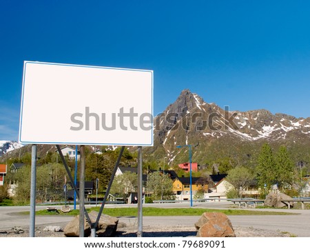 Big white billboard in the background of rocky mountains