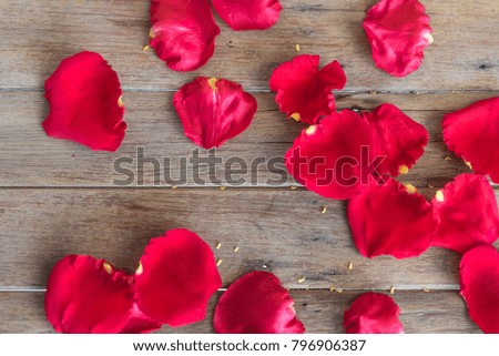 Petal of red rose flower nature beautiful flowers from the garden on wooden floor with copy space in Valentine's Day, Wedding or Romantic Love concept