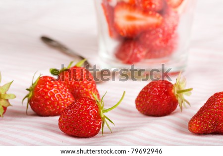 Strawberries and dessert with cream in glass