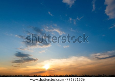 beautiful view of colorful sunset sky with cloud at evening and silhouette city on foreground Royalty-Free Stock Photo #796931536