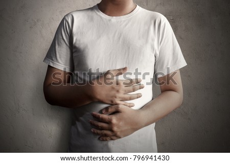 Man holding stomach Royalty-Free Stock Photo #796941430