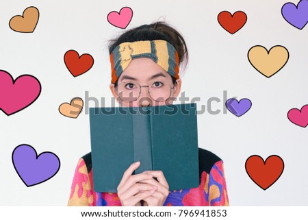 Valentines Day concept- Headshot portrait of young asian woman wearing glasses and holding a book with colorful different colours of heart illustration doodle icon at the back ground