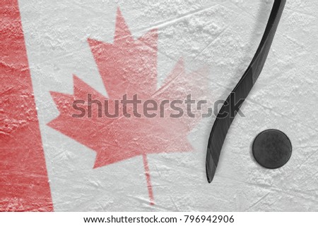 Hockey puck, stick, and the image of the Canadian flag on the ice. Concept, hockey