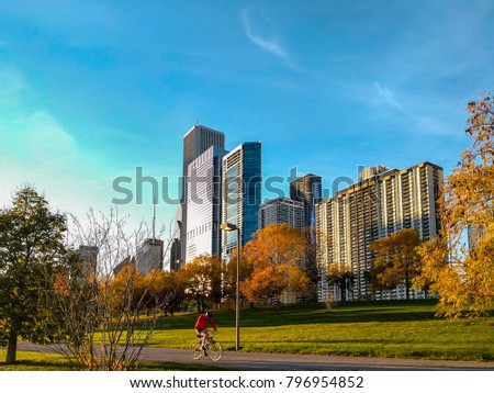 An autumn scene of a cyclist on Chicago's lakefront trail. Urban, city landscape. Royalty-Free Stock Photo #796954852