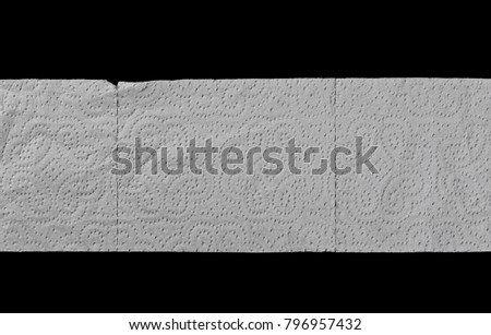 Toilet paper isolated on black background, top view