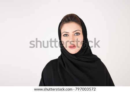 Beautiful Arab woman in traditional dress on white background