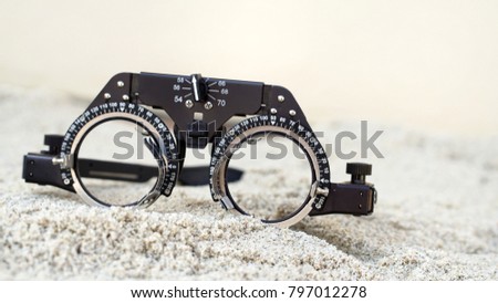 Ophthalmologist, eyeglasses, glasses on the sand.