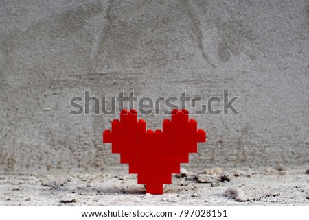 A red heart on cement background