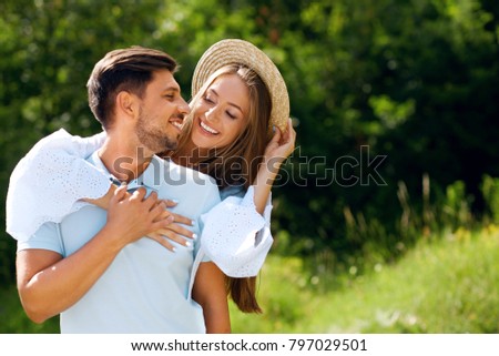 Beautiful Couple In Love Embracing Each Other In Nature. Portrait Of Happy Woman And Handsome Young Man In Stylish Clothes Hugging And Enjoying Date Outdoors. Romantic Relationship. High Resolution.