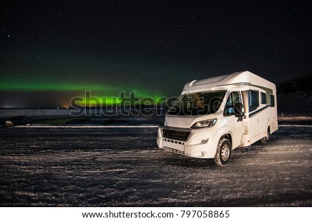motorhome on a plain with nothern lights background Royalty-Free Stock Photo #797058865