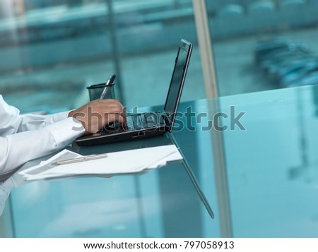 Saudi Man Hands Typing On Laptop at His Desk.