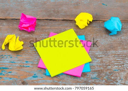 sticky note with crumpled papers  on wooden background, business concept on the sticky note.