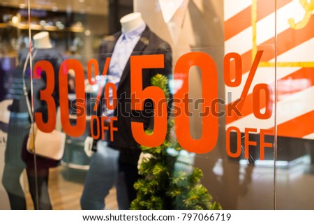 Boutique and Sale sign.Shop window display in the post about sales.announcement of a fifty-percentage discount on a glass show-window.shopping and discount concept. 